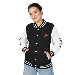 Person wearing a black and white varsity jacket with a red logo 