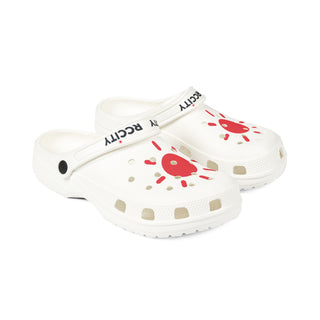 White children's clogs with red and gold designs 