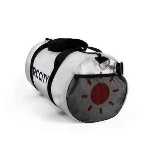 White duffel bag with black straps and a red sun design - RC city