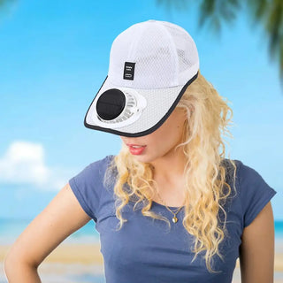 Person wearing a white cap with a black visor on a beach