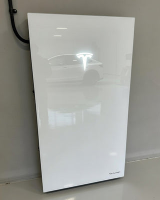 White electronic device on a gray floor against a beige wall