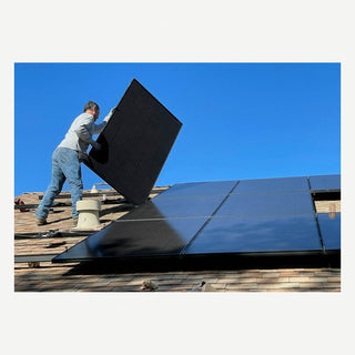 Solar panels being mounted on residential roof racking — realistic install photo
